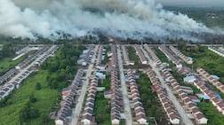 Smoke rises from a wildfire next to a housing complex in Indonesia. AFP
