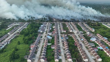 Smoke rises from a wildfire next to a housing complex in Indonesia. AFP