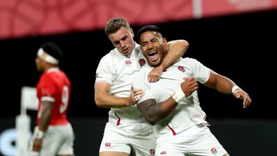 Manu Tuilagi, right, celebrates with teammate George Ford after scoring his second try against Tonga in their Rugby World Cup opener on Saturday. Getty
