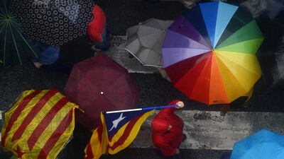 Pro independence demonstrators hold their umbrellas as they gather in front of the city hall building during a protest at the Sant Jaume square in Barcelona, Spain. Manu Fernandez / AP