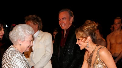 Queen Elizabeth greets singer Kylie Minogue. Getty