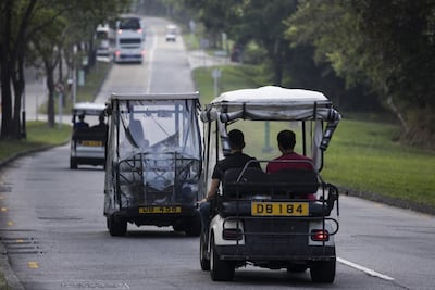 Golf carts travel along a road in Discovery Bay.