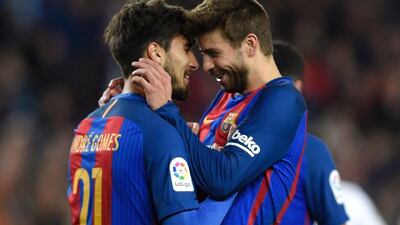 Gerard Pique, right, celebrates with Adnre Gomes after his goal against Valencia on Sunday. Lluis Gene / AFP