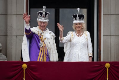 King Charles III and Queen Camilla wave from the Buckingham Palace balcony during the coronation celebrations. Getty