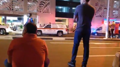 Residents of Dubai's Torch Tower wait to be allowed back into the building after a small fire. Courtesy Martin Yofre