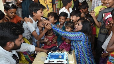 Narendra Modi Fan Club members offer cake to underprivileged children as they celebrate his swearing-in ceremony iN Ahmedabad. AFP