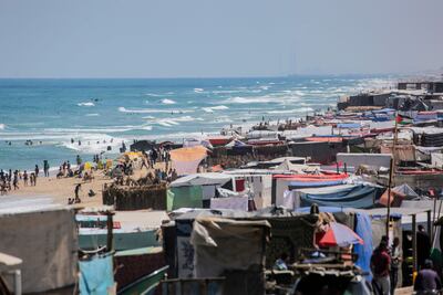 Tents and shacks housing displaced Palestinians crowd the Mediterranean seashore in Deir El Balah in the central Gaza Strip on May 15. AFP