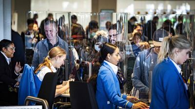 Travellers wait at check-in at Schiphol Airport during strikes last weekend. AFP