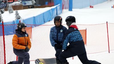 Snowboarders Abdullah Al Nuaimi and Meena Al Mazrouei train with coach Lina Reda, left