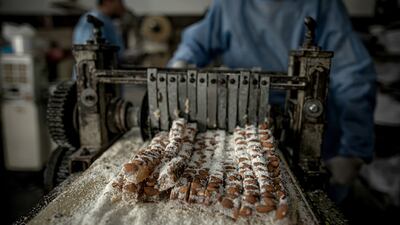 Workers make 'Halkoum' sweets.