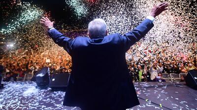 Newly elected president of Mexico, Andres Manuel Lopez Obrador, cheers with his supporters at Zocalo Square in Mexico City. Pedro Pardo / AFP