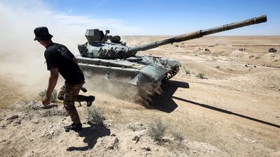 T-72M tank belonging to the pro-government Hashed Al Shaabi (PMF) paramilitary forces advances towards Hatra, south-west of Mosul, during an offensive to retake the area from ISIL on April 26, 2017. Ahmad Al Rubaye / AFP