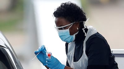 Medical staff at an NHS drive through coronavirus disease testing facility in the car park of Chessington World of Adventures. Reuters