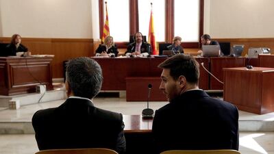 Barcelona’s Lionel Messi sits in court with his father Jorge Messi during their trial for tax fraud in Barcelona in June. Alberto Estevez / Reuters