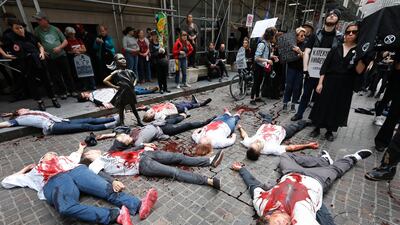 Activists with the Extinction Rebellion movement demonstrate outside the New York Stock Exchange, and the Defiant Girl statue, Monday, October 7, 2019, kicking off a wide-ranging series of worldwide protests demanding much more urgent action against climate change. AP Photo/Richard Drew