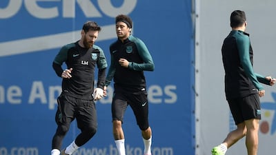 Lionel Messi, Neymar and Uruguayan Luis Suarez take part in a drill. Lluis Gene / AFP