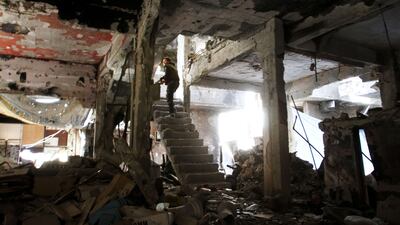 A man stands on a staircase inside a demolished building in the Yarmouk Palestinian refugee camp in the Syrian capital Damascus on April 6, 2015. Around 2,000 people have been evacuated from the camp after ISIL seized large parts of it. Youssef Karwashan/AFP Photo