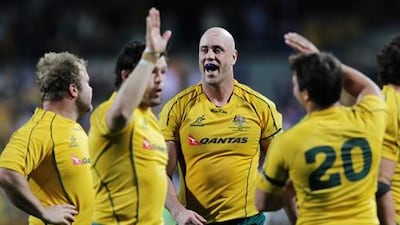 Australia veteran Nathan Sharpe celebrates with teammates after the win over South Africa.