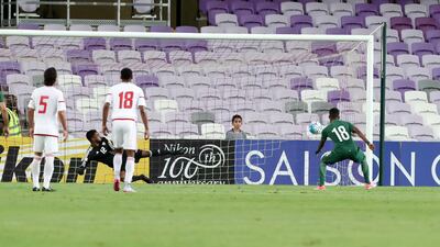 Nawaf Alabid, left, scores from a penalty as Saudi Arabia take a 1-0 lead at Hazza bin Zayed Stadium on Tuesday. Chris Whiteoak / The National
