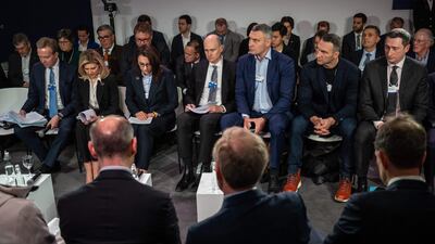 Ukraine's First Lady Olena Zelenska, Kyiv mayor Vitali Klitschko and Wladimir Klitschko observe a moment of silence during the World Economic Forum in Davos, Switzerland. AFP