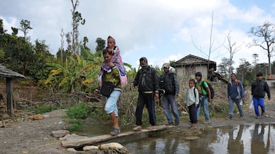 Chandra Bahadur Dangi (top L), a 72-year-old Nepali who claims to be the world's shortest man at 56 centimetres (22 inches) in height, is carried by a relative on the way to his home village in Dang district, some 540 kilometres southwest of Kathmandu. ???