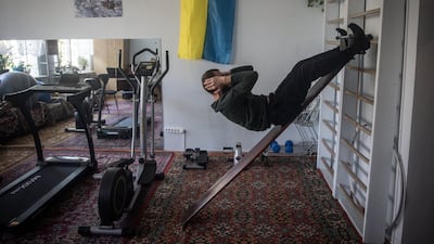 Leonid, a 38-year-old Ukrainian soldier suffering from severe mental trauma, cranial trauma and shrapnel wounds, does his physical training session at a psychiatric hospital in Kyiv, in October 2023. Getty Images
