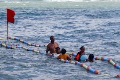 A lifeguard helps visually impaired children swim at Al Mandara beach on the Mediterranean coast in Alexandria. Reuters