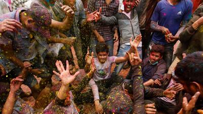People throw coloured powder at each other as they gather to celebrate Holi, the festival of colours, in Kathmandu, Nepal. Reuters