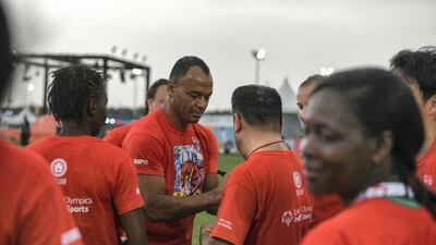 Cafu signs T-shirts of his fans.