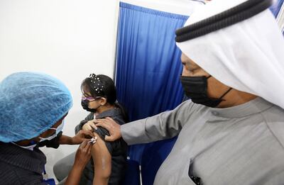 A girl receives a Covid-19 vaccine in Kuwait. AFP