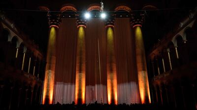 French high-wire artist Philippe Petit performs during a fundraiser at the National Building Museum in Washington. AFP