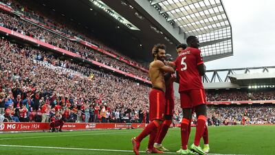 Liverpool's Egyptian midfielder Mohamed Salah (L) celebrates with teammates after scoring their second goal during the English Premier League football match between Liverpool and Crystal Palace at Anfield in Liverpool, north west England on September 18, 2021. (Photo by Paul ELLIS / AFP) / RESTRICTED TO EDITORIAL USE. No use with unauthorized audio, video, data, fixture lists, club/league logos or 'live' services. Online in-match use limited to 120 images. An additional 40 images may be used in extra time. No video emulation. Social media in-match use limited to 120 images. An additional 40 images may be used in extra time. No use in betting publications, games or single club/league/player publications. /
