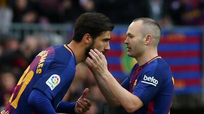 Andre Gomes, left, comes on as a substitute to replace Andres Iniesta against Atletico Madrid and was booed by some home fans. Albert Gea / Reuters