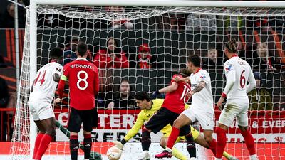 Manchester United's Marcel Sabitzer, centre, in action against Sevilla goalkeeper Bono. EPA