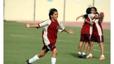Ronya Brahim, 11, from Cambridge High School, celebrates after scoring a goal yesterday.