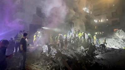 Emergency workers and volunteers search for victims at the site of an Israeli air strike in central Beirut, Lebanon. AP