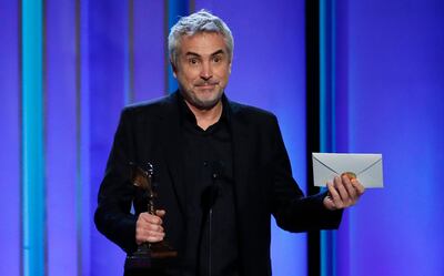 Alfonso Cuaron accepts the Best International Film award for 'Roma'. Reuters