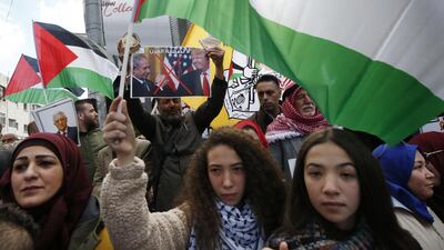 Palestinians women wave national flags as they protest a US peace plan proposal in the centre of the Hebron in the Israeli-occupied West Bank on January 30, 2020 AFP