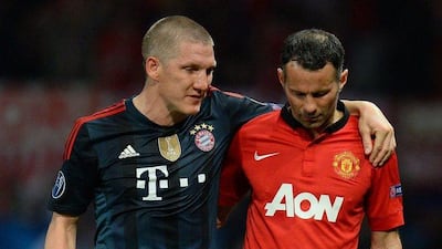 Picture taken on April 1, 2014 shows then Manchester United's Ryan Giggs, right, and Bayern Munich's Bastian Schweinsteiger during a Uefa Champions League match. Schweinsteiger is set to be re-united with his former coach Louis van Gaal at Manchester United. AFP PHOTO / ANDREW YATES