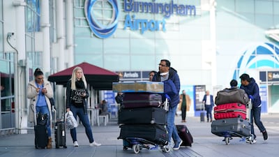 Passengers arrive at Birmingham Airport on Monday morning, as travel between the UK and dozens of countries reopened after the government lifted restrictions. PA
