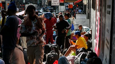 Migrants wait outside of the former Roosevelt Hotel in New York. EPA-EFE