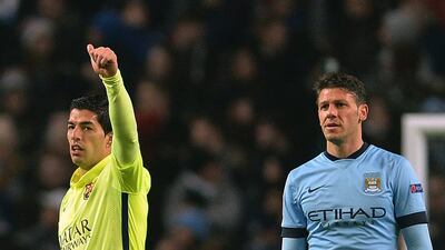 Barcelona's Luis Suarez celebrates after scoring his first goal against Manchester City on Tuesday night in their Champions League contest. Peter Powell / EPA