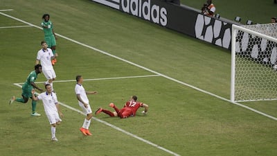 Wilfried Bony, far left in green, scores Ivory Coast's equaliser to make it 1-1 in their eventual 2-1 loss to Greece on Tuesday at the 2014 World Cup. Sergei Grits / AP