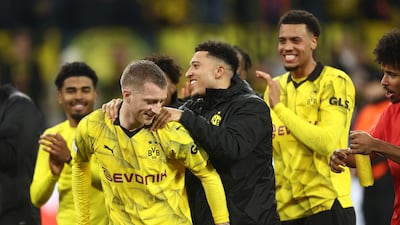 Marco Reus and Jadon Sancho celebrate victory in the Champions League Round of 16. Getty Images