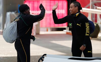 Jazmine Fenlator-Victorian and Carrie Russell of Jamaica trade high-fives. Edgar Su / Reuters