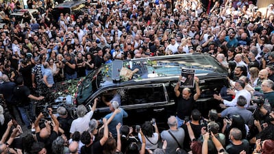TOPSHOT - Mourners gather around the hearse of Lebanese musician and composer Ziad Rahbani outside Khoury Hospital in Beirut's central Hamra district on July 28, 2025. Lebanon mourned musician and composer Ziad Rahbani, son of iconic singer Fairuz and a musical pioneer in his own right, who died on July 26 aged 69 after a decades-long career that revolutionised the country's artistic scene. (Photo by Anwar AMRO / AFP)