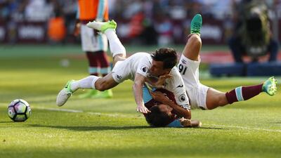 West Ham United's Mark Noble tumbles with Swansea City's Jack Cork in a battle for possession. Eddie Keogh / Reuters