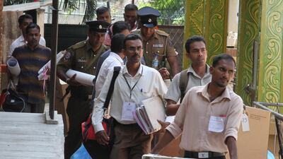 Sri Lankan polling officers in Colombo carry election materials as they leave for their respective polling booths on the eve of the presidential election. EPA