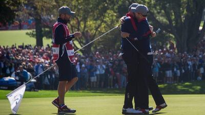 USA’s Zach Johnson, right, hugs Jimmy Walker as they celebrate winning during the morning foursomes at the Ryder Cup. Jim Watson / AFP
