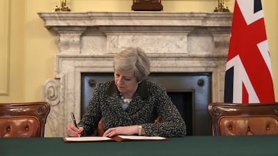 British prime minister Theresa May signs the official letter to launch Brexit. Christopher Furlong / Reuters